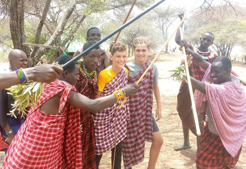 Maasai male in the village with guests